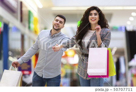 Consumerism And Sale Concept. Lovely Couple Shopping Together Consumerism And Sale Concept. Lovely Couple Shopping Together 50707711