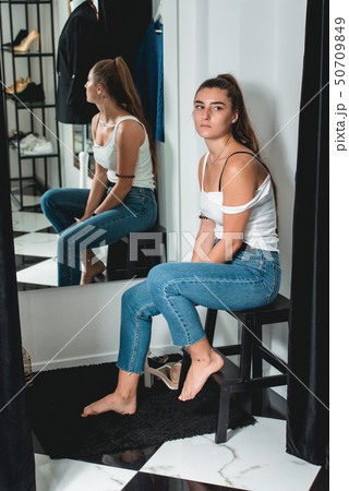 Shot of a beautiful woman in the fitting room. 50709849