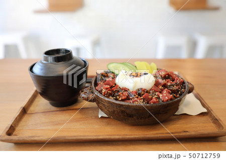 Steak tuna on rice with egg Japanese style on wooden table Steak tuna on rice with egg Japanese style on wooden table 50712759