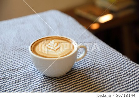 cappuccino or Latte art coffee made from milk on the wood table in coffee shop 50713144