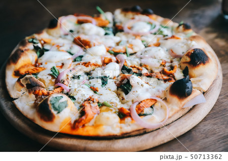 Tandoori Chicken Pizza on wooden table Tandoori Chicken Pizza on wooden table 50713362