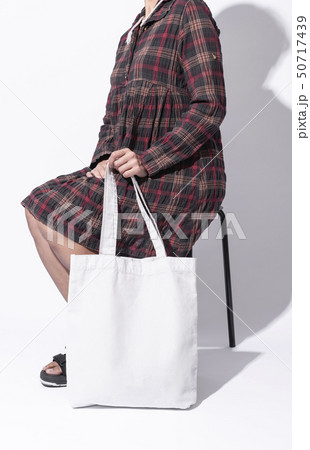 Girl is holding bag canvas fabric for mockup blank 50717439