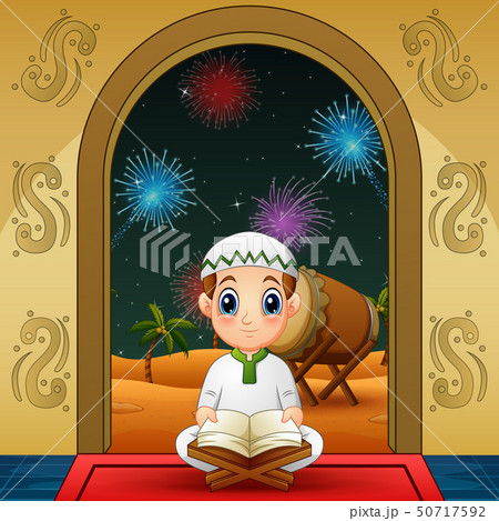 Cute Little muslim boy reading Quran at night 50717592
