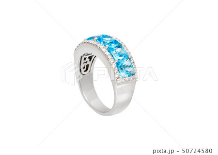 Diamond ring with blue precious gems. White golden ring on white background. Fashion luxury 50724580