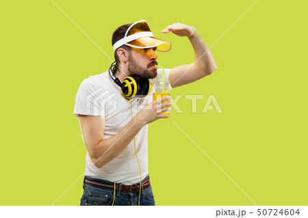 Half-length close up portrait of young man on yellow background 50724604