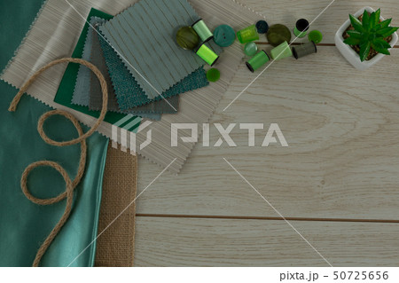 Textile and thread rolls on a table 50725656