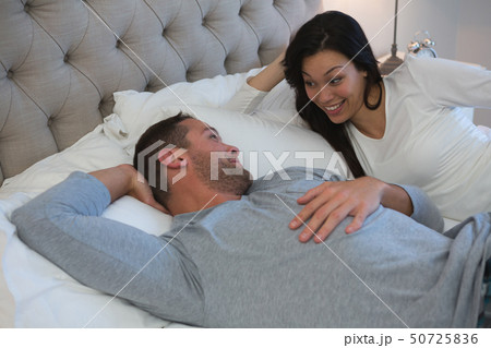 Couple interacting with each other while sleeping in bedroom Couple interacting with each other while sleeping in bedroom 50725836