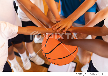 Close-up of Schoolkids forming hand stack on basketball at basketball court 50725910
