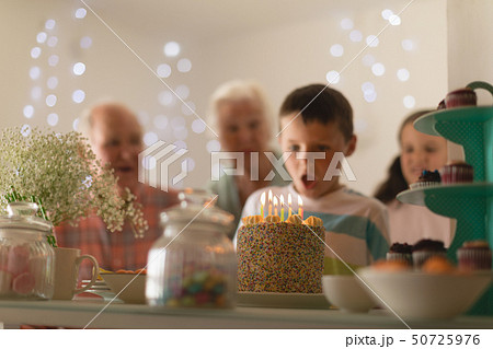 Multi-generation family celebrating birthday of grandson 50725976