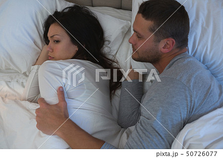 Angry couple avoiding each other in bedroom 50726077