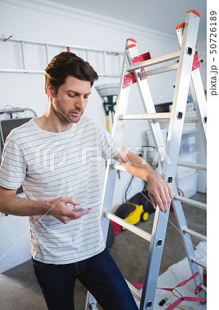 Male painter using mobile phone Male painter using mobile phone 50726189