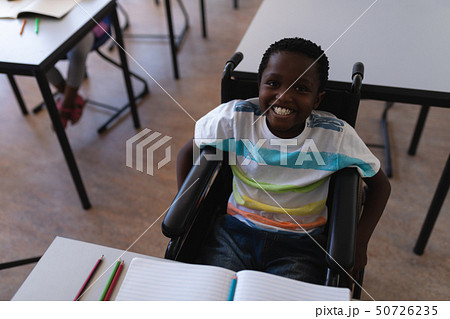Disable schoolboy looking at camera in classroom Disable schoolboy looking at camera in classroom 50726235