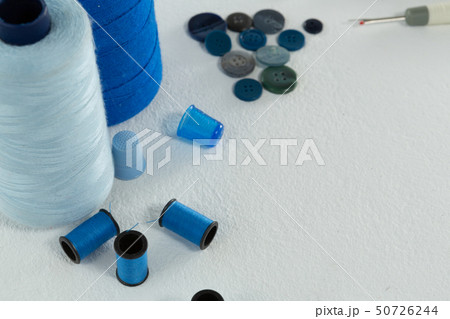 Thread rolls and various tools on white background 50726244