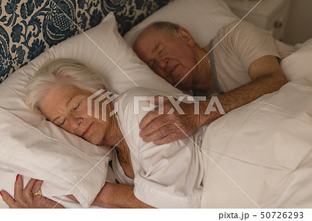 Senior couple sleeping together in bedroom Senior couple sleeping together in bedroom 50726293