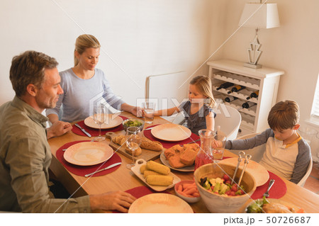 Family praying before having food on dining table Family praying before having food on dining table 50726687