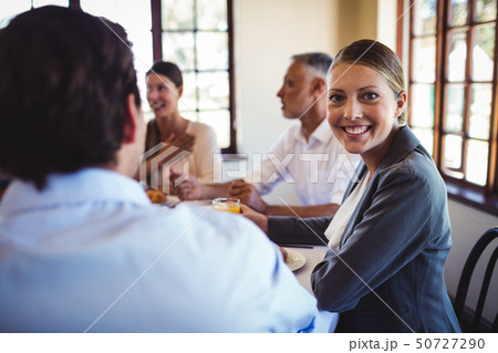 Businesswoman looking at camera in restaurant 50727290