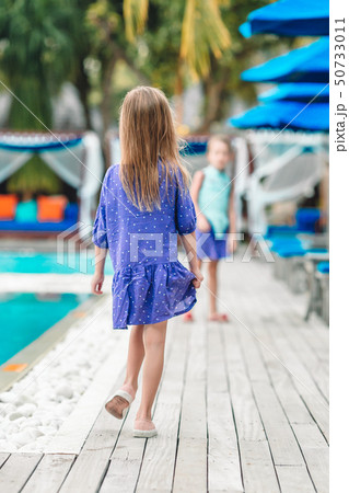 Back view of little kid enjoy vacation in the swimming pool Back view of little kid enjoy vacation in the swimming pool 50733011