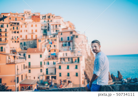 Tourist looking at scenic view of Manarola, Cinque Terre, Liguria, Italy Tourist looking at scenic view of Manarola, Cinque Terre, Liguria, Italy 50734111