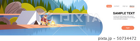 woman hiker making fire near tent camp african girl holding firewood for bonfire hiking camping woman hiker making fire near tent camp african girl holding firewood for bonfire hiking camping 50734472