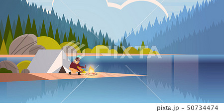 woman hiker making fire near tent camp african american girl holding firewood for bonfire hiking 50734474