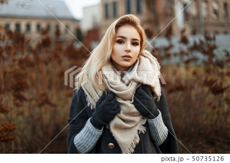 Pretty woman in stylish knitted scarf Pretty woman in stylish knitted scarf 50735126