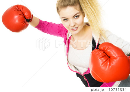 Woman wearing boxing gloves Woman wearing boxing gloves 50735354
