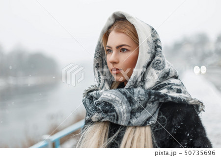 Beautiful young woman wearing a scarf Beautiful young woman wearing a scarf 50735696