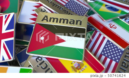 Souvenir magnet or badge with Amman text and national flag among different ones. Traveling to Jordan 50741624