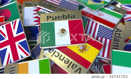 Souvenir magnet or badge with Puebla text and national flag among different ones. Traveling to Souvenir magnet or badge with Puebla text and national flag among different ones. Traveling to 50741703