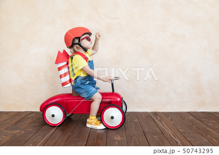 Kid playing with toy rocket at home Kid playing with toy rocket at home 50743295