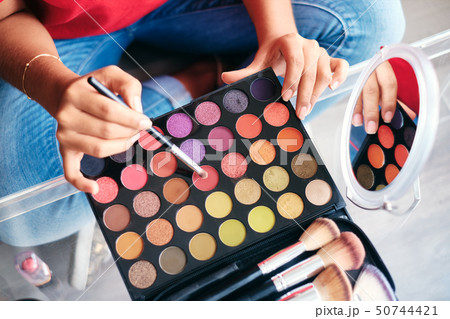 Mirror Close-Up Of Young Woman Applying Make-Up For Beauty 50744421