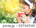 Pretty woman enjoying a cup of coffee in breaking  50744540