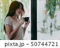 Young pretty woman enjoying a cup of coffee 50744721