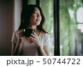 Young pretty woman enjoying a cup of coffee 50744722