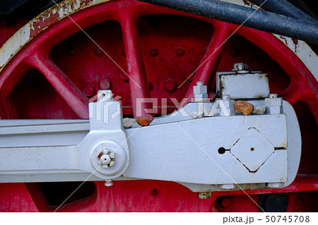 Vintage steam locomotive detail with cranks and red wheels 50745708