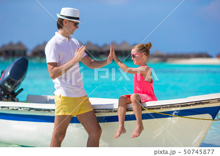 Little girl and dad on boat during tropical beach vacation 50745877