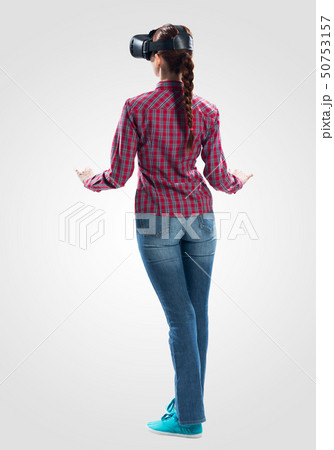 Young woman wearing VR headset and gesturing 50753157