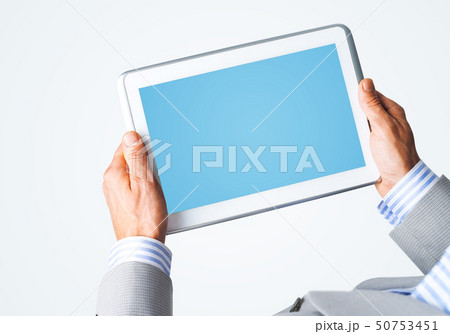 Hands of businessman holding tablet pc with blue screen 50753451