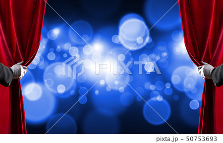 Bokeh lights behind drapery curtain and hand opening it Bokeh lights behind drapery curtain and hand opening it 50753693