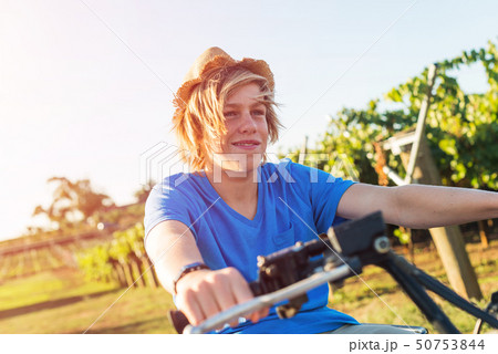 Young farmer riding quad bike Young farmer riding quad bike 50753844