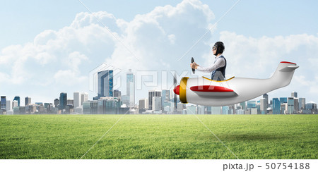 Happy aviator driving small propeller plane 50754188