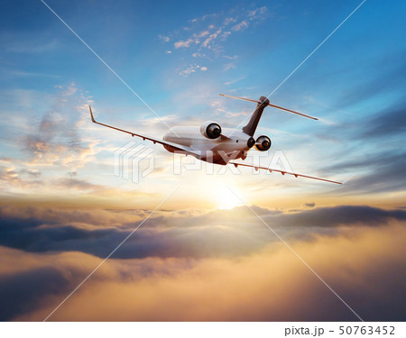 Private jet plane flying in sunset Private jet plane flying in sunset 50763452