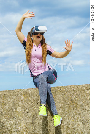 Woman wearing VR outside 50763504