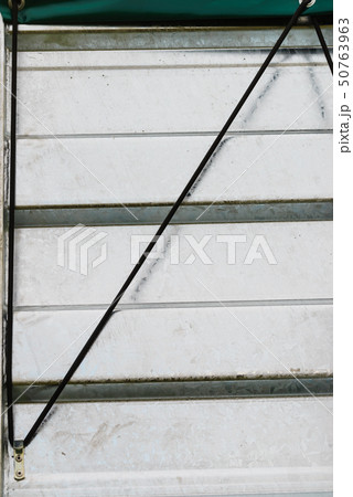 Black single safety link string on white tinware Black single safety link string on white tinware 50763963