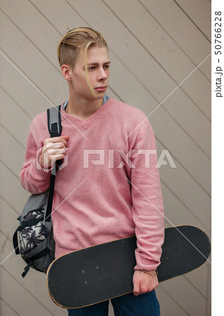 Young fashionable handsome man with a backpack Young fashionable handsome man with a backpack 50766228