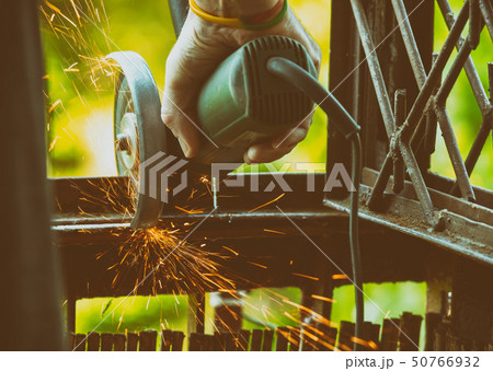 Man using angle grinder 50766932