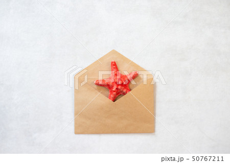 Blank beige envelope and starfish on white background Blank beige envelope and starfish on white background 50767211