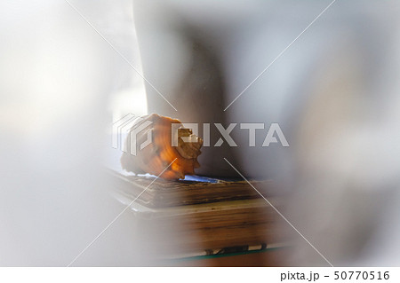 A large sea shell lies on a stack of old books on A large sea shell lies on a stack of old books on 50770516