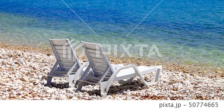 Two deck chairs on beach in sunny autumn day 50774665