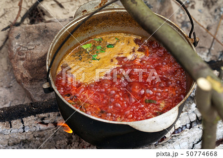 Ukrainian traditional soup cooking in old sooty 50774668
